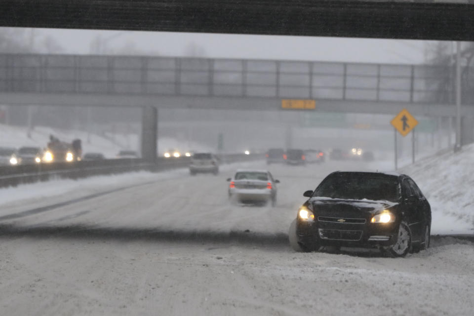 A vehicle spins out on Interstate 94 in Detroit, Saturday, Jan. 19, 2019. The massive storm dumped 10 inches of snow on some areas of the Midwest. Following the storm system, some areas were expecting high winds and bitter cold, and in Iowa, temperatures in the teens Saturday were expected to drop below zero overnight, producing wind chills as low as 20-below by Sunday morning. (AP Photo/Paul Sancya)