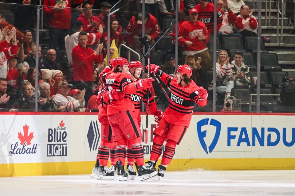 Detroit Red Wings celebrate a goal by Dylan Larkin during the first period against the Vancouver Canucks at Little Caesars Arena, Feb. 11, 2023.