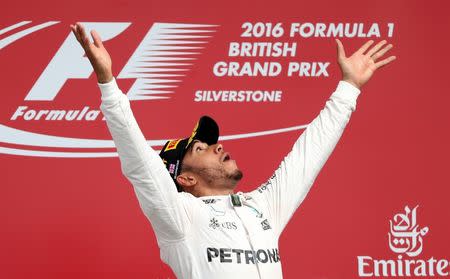 Britain Formula One - F1 - British Grand Prix 2016 - Silverstone, England - 10/7/16 Mercedes' Lewis Hamilton celebrates on the podium after winning the race REUTERS/Matthew Childs Livepic EDITORIAL USE ONLY.