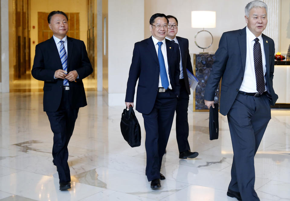 FILE - In this Feb. 13, 2018, file photo, Chinese Ambassador to the Philippines Zhao Jianhua, left, and other Chinese Foreign Ministry officials walk back to their meeting with Philippine counterpart on the second Bilateral Consultation Mechanism (BCM) on South China Sea, at suburban Taguig city, east of Manila, Philippines. The Philippines has expressed concern to China over an increasing number of Chinese radio messages warning Philippine aircraft and ships to stay away from newly fortified islands and other territories in the South China Sea claimed by both countries, officials said Monday, July 30, 2018. (AP Photo/Bullit Marquez, File)