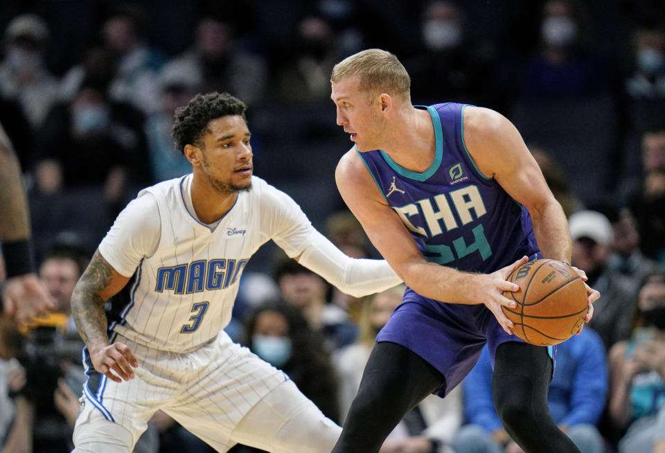 Orlando Magic forward Chuma Okeke (3) guards Charlotte Hornets center Mason Plumlee (24) during the first half of an NBA basketball game on Friday, Jan. 14, 2022, in Charlotte, N.C. (AP Photo/Rusty Jones)