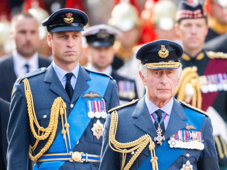 King Charles III and Prince William walk behind Queen Elizabeth II's coffin as it is taken from Buckingham Palace to Westminster Hall on September 14, 2022.