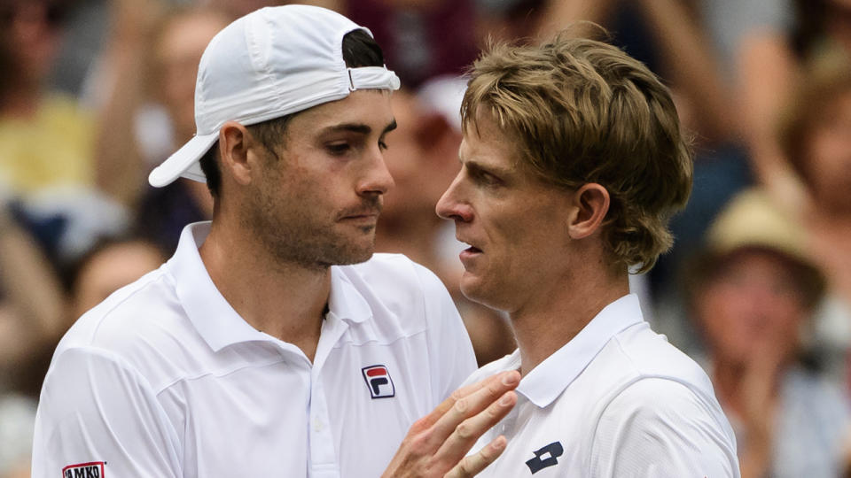 LONDON, ENGLAND – JULY 13: Kevin Anderson of South Africa commiserates with John Isner of the United States after beating him in the semi final of the gentlemen’s singles at the All England Lawn Tennis and Croquet Club on July 13, 2018 in London, England. (Photo by TPN/Getty Images)