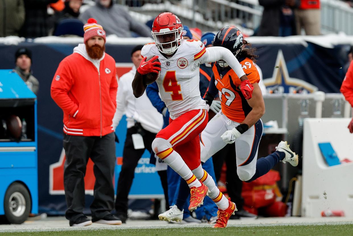 Oct 29, 2023; Denver, Colorado, USA; Kansas City Chiefs wide receiver Rashee Rice (4) runs the ball ahead of linebacker Alex Singleton (49) in the second quarter at Empower Field at Mile High. Mandatory Credit: Isaiah J. Downing-USA TODAY Sports