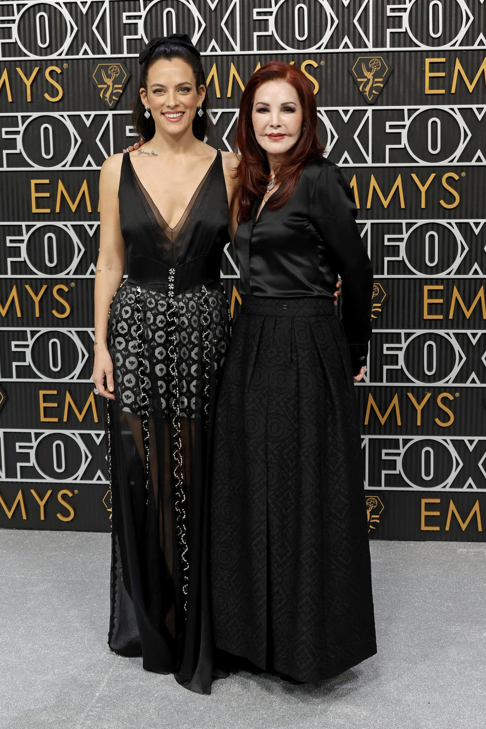 Riley Keough in black chanel and grandmother Priscilla Presley at the 2024 Emmys. (Image via Getty Images)