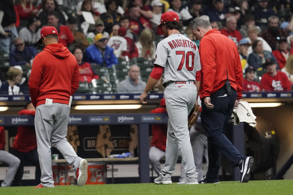 St. Louis Cardinals' Packy Naughton (70) is taken out of the baseball game against the Milwaukee Brewers after suffering an injury during the eighth inning, Friday, April 7, 2023, in Milwaukee. (AP Photo/Aaron Gash)