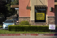 FILE - A hiring sign hangs in the window of a Taco Bell in Sacramento, Calif. on July 15, 2021. California's unemployment rate dipped a half-percentage point in December as the most populous state added 50,700 nonfarm jobs, accounting for more than a quarter of the nation's 199,000 job growth for the month, according to new data released Friday, Jan. 21, 2022. (AP Photo/Rich Pedroncelli, File)