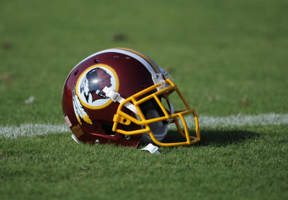 A Washington Redskins football helmet lies on the field during NFL football minicamp, Wednesday, June 18, 2014, in Ashburn, Va. The U.S. Patent Office ruled Wednesday, June 18, 2014, that the Washington Redskins nickname is &quot;disparaging of Native Americans&quot; and that the team&#39;s federal trademarks for the name must be canceled. The ruling comes after a campaign to change the name has gained momentum over the past year.  (AP Photo/Nick Wass)