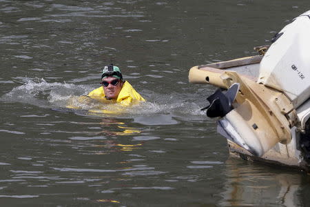 Christopher Swain, a clean-water activist, swims in the Gowanus Canal in the Brooklyn borough of New York April 22, 2015. REUTERS/Shannon Stapleton