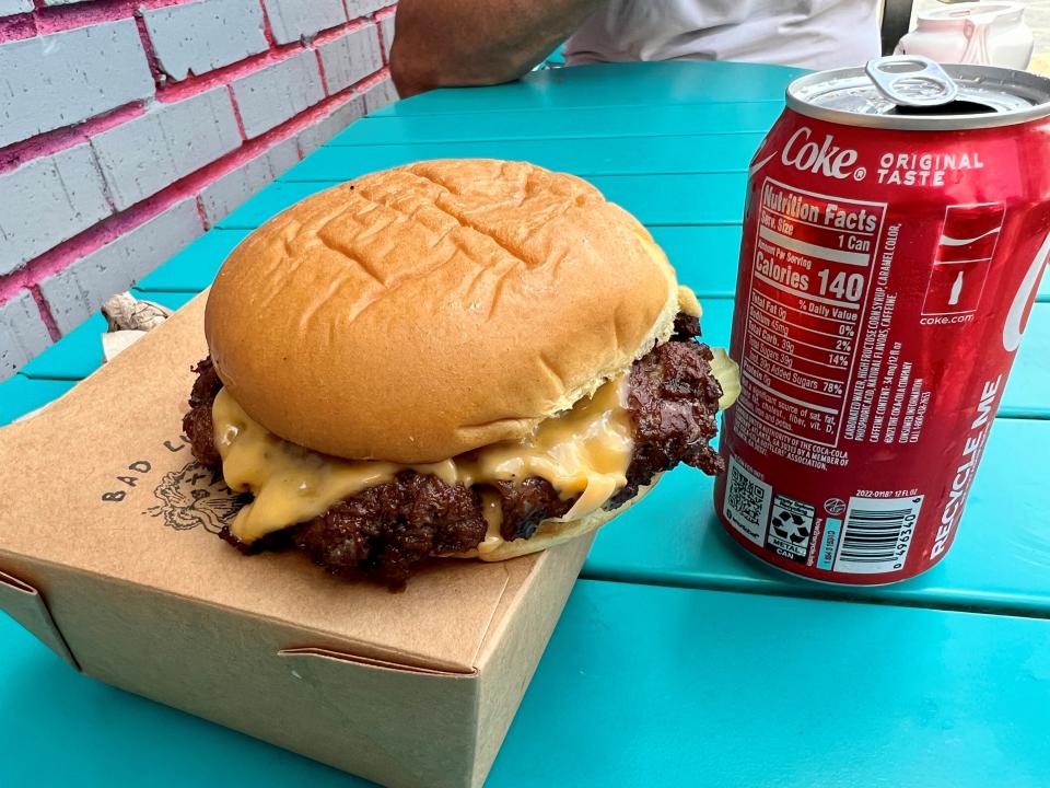 A burger and Coke from Bad Luck Burger Club food truck July 30, 2023, in East Nashville