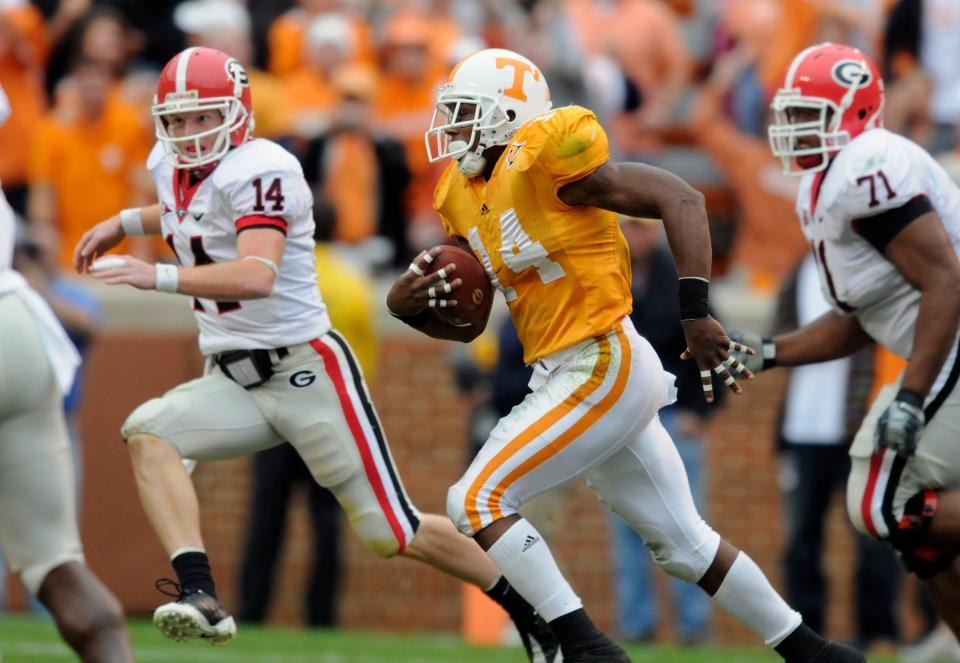Eric Berry (14) returns one of his 14 career interceptions at Tennessee, with Georgia quarterback Joe Cox (14) in pursuit, Oct. 10, 2009 at Neyland Stadium.