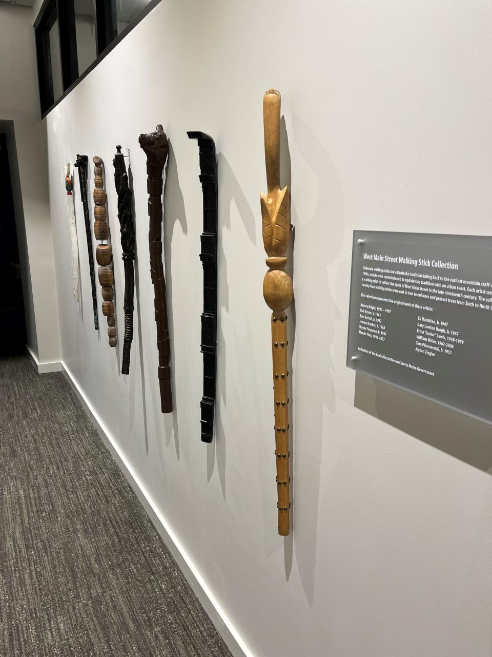 Wooden walking sticks, commissioned from local artists and used to create tree guards on Main Street in 1995, are displayed in the offices of Leadership Louisville.