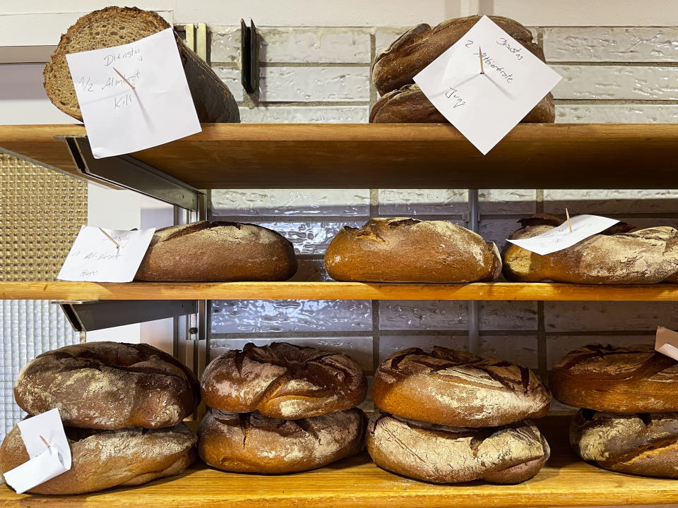 Bread that was baked with beer is displayed at the Coelven bakery in Duesseldorf, Germany, Tuesday, March 23, 2021. The historic Fuechschen brewery in Duesseldorf, has about 6,000 litres of its renowned copper-colored 'Altbier' unsold and nearing its expiry date. The brewery is now working with craft bakers who use the beer to make bread, with about twelve bakeries producing the grain bread and are giving the additional bonus of a bottle of Fuechschen's Altbier free of charge with every loaf.(AP Photo/Daniel Niemann)