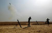 Iraqi forces fire mortar shells towards the village of Tall al-Tibah, some 30 kilometres south of Mosul, on October 19, 2016