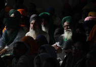 Sikh farmers listen to their leaders speak at Singhu, the Delhi-Haryana border camp for protesting farmers against three farm bills, in New Delhi, India, Wednesday, Jan. 27, 2021. Leaders of a protest movement sought Wednesday to distance themselves from a day of violence when thousands of farmers stormed India's historic Red Fort, the most dramatic moment in two months of demonstrations that have grown into a major challenge of Prime Minister Narendra Modi’s government. (AP Photo/Manish Swarup)