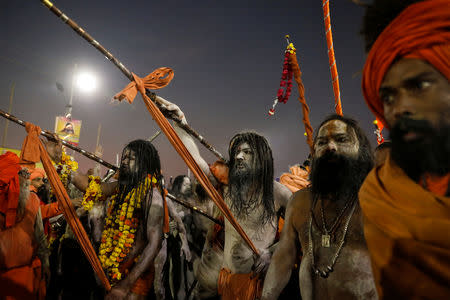 Naga Sadhus or Hindu holy men arrive to take a dip during the first "Shahi Snan" (grand bath) during "Kumbh Mela" or the Pitcher Festival, in Prayagraj, previously known as Allahabad, India, January 15, 2019. Picture taken January 15, 2019. REUTERS/Danish Siddiqui