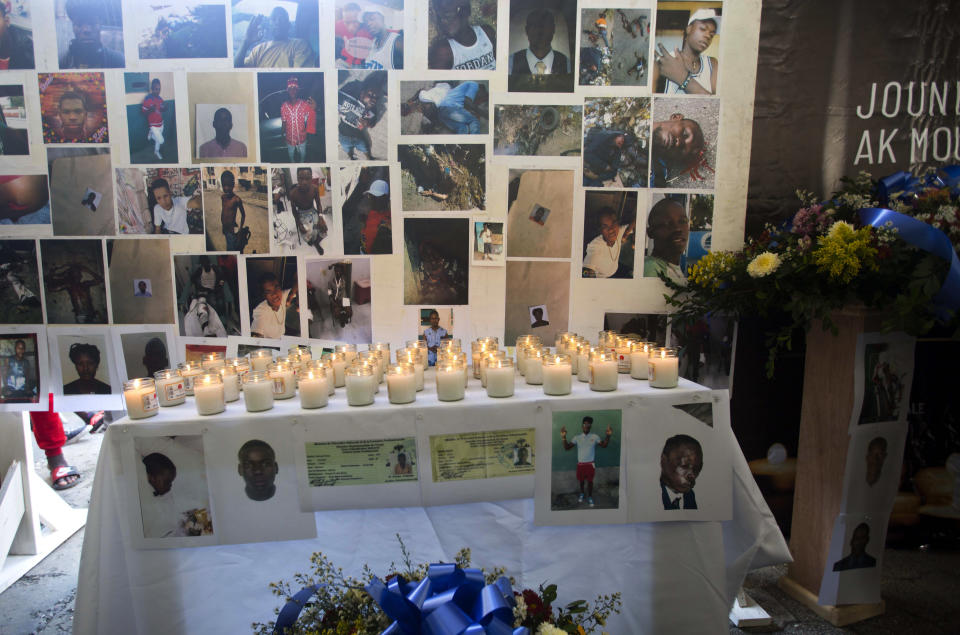 In this Dec. 13, 2018 photo, pictures, candles and flowers decorate an altar for the massacre victims during a memorial in the La Saline slum of Port-au-Prince, Haiti. Eyewitnesses, a human-rights group and a Catholic charity that collected bodies after the Nov. 13 massacre told The Associated Press that at least 20 people, mostly men, were slain over a 24-hour period in La Saline. Another human-rights group put the toll far higher, at 59, but the AP was unable to corroborate that figure. (AP Photo/Dieu Nalio Chery)