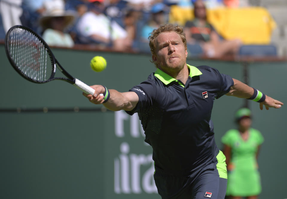 Dmitry Tursunov, of Russia, hits to Roger Federer, of Switzerland, during a third round match at the BNP Paribas Open tennis tournament, Monday, March 10, 2014, in Indian Wells, Calif. (AP Photo/Mark J. Terrill)