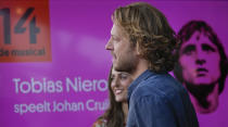 Tobias Nierop, who plays soccer legend Johan Cruyff, and Myrthe Burger, rear, who plays his wife Danny, are seen during a presentation of "14 The Musical" in Leusden, Netherlands, Friday, June 11, 2021. On the opening day of the pandemic-delayed European 2020 Soccer Championship, the cast and crew of "14 The Musical", referring to Cruyff's shirt number, raised the curtain on the new musical eulogizing the country's most famous footballing son, Johan Cruyff. (AP Photo/Peter Dejong)