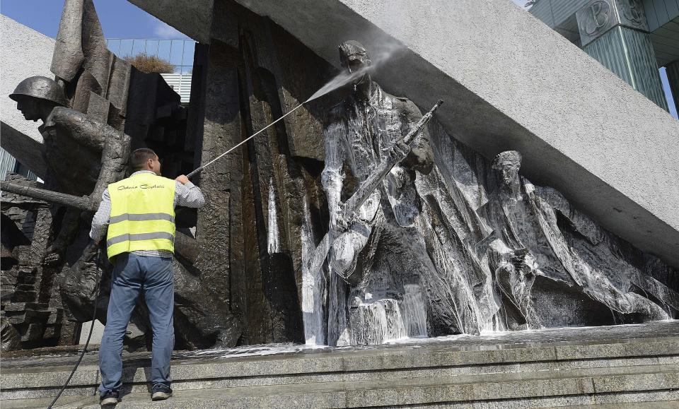 FILE - In this file photo from July 26, 2019, a worker washes a monument dedicated to the fighters of the 1944 Warsaw Rising against the occupying Nazi Germans ahead of ceremonies next week marking the 75th anniversary of the heroic struggle, in Warsaw, Poland. On Thursday Aug. 1, 2019, Warsaw will honour the failed Warsaw Rising, which had been a taboo topic during four decades of communist rule imposed on Poland after the war.(AP Photo/Czarek Sokolowski, FILE)