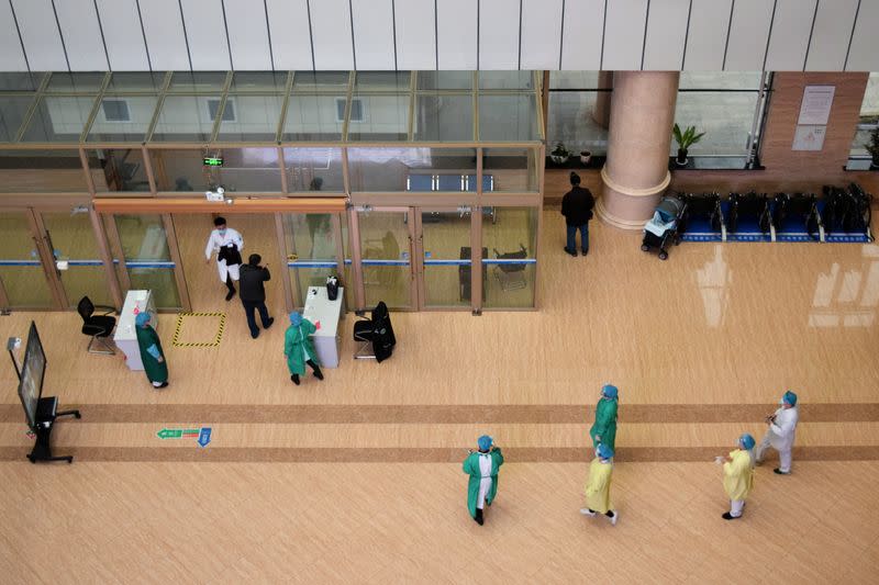 Medical workers are seen near the entrance at a hospital in Suifenhe