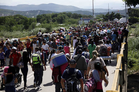 People cross the Colombian-Venezuelan border over the Simon Bolivar international bridge in San Antonio del Tachira, Venezuela May 16, 2018. Picture taken May 16, 2018. REUTERS/Carlos Eduardo Ramirez