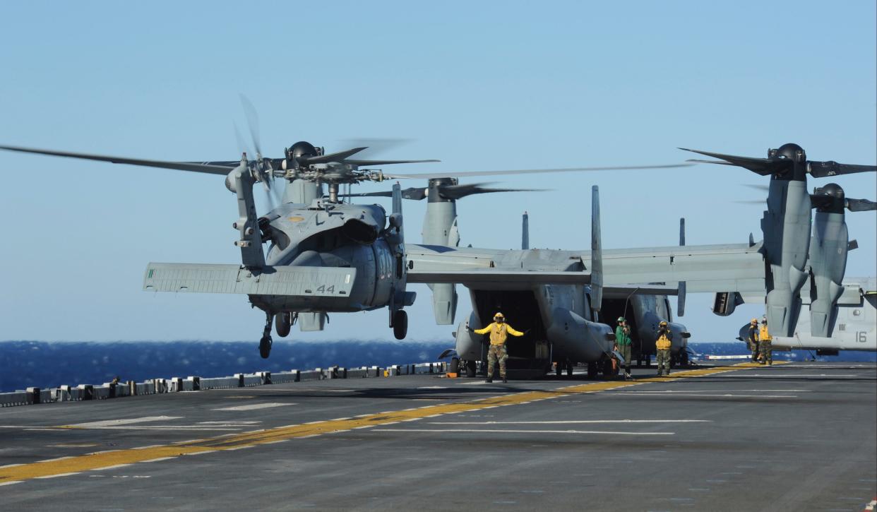 An SH-60 Sea Hawk helicopter lands on the flight deck aboard the multipurpose amphibious assault ship USS Bataan