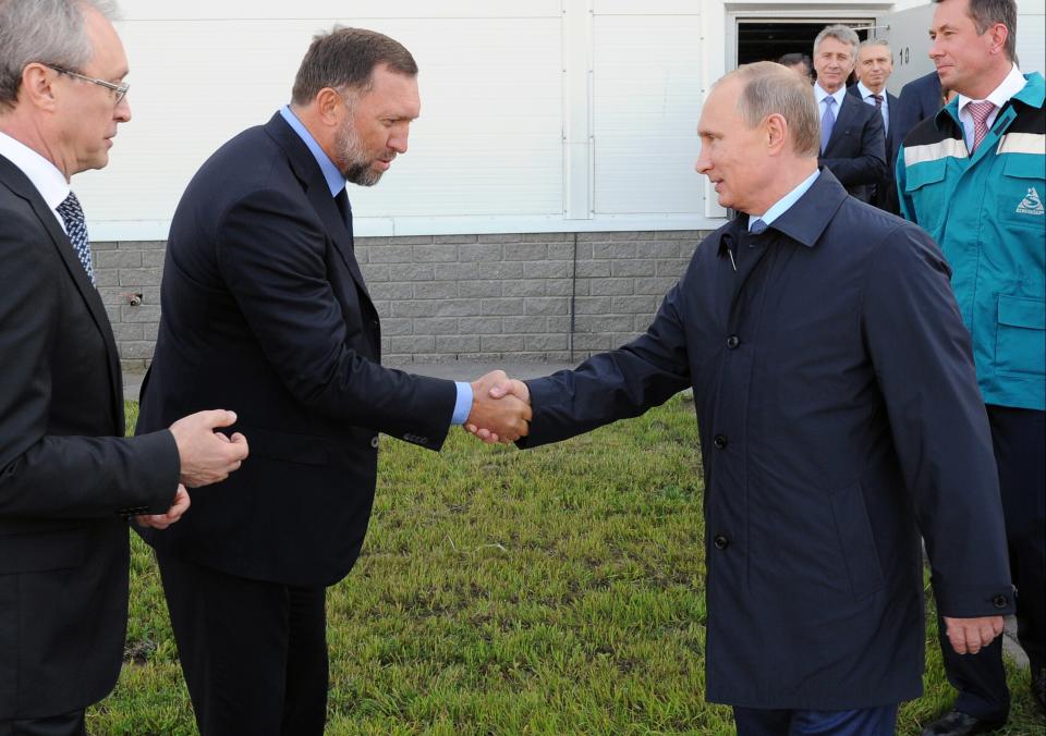 FILE - In this Sept. 19, 2014 file-pool photo, Russian President Vladimir Putin, right, shakes hands with Russian metals magnate Oleg Deripaska while visiting the RusVinyl plant in Kstovo, in Russia's Nizhny Novgorod region. Deripaska says he is willing to take part in U.S. congressional hearings to discuss his relationship with President Donald Trump’s former campaign chairman, Paul Manafort. (AP Photo/RIA-Novosti, Mikhail Klimentyev, Presidential Press Service, File)