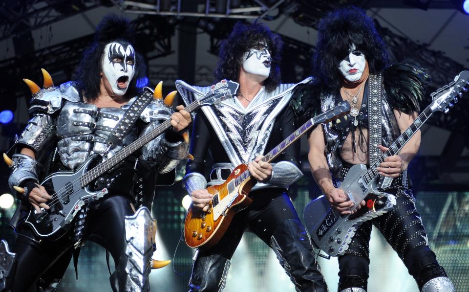 FILE - In this Thursday June 13, 2013, file photo, from left: bassist Gene Simmins , guitarist Tommy Thayer and singer Paul Stanley of the US band Kiss perform on stage in Berlin, Germany. Kiss announced Sunday, Feb. 23, 2014 that the band will not perform when they are inducted into the Rock and Roll Hall of Fame in Cleveland in April. The 40-year-old band is unable to agree on which lineup should perform during the April 10 ceremony in New York City. (AP Photo/dpa,Britta Pedersen, File)