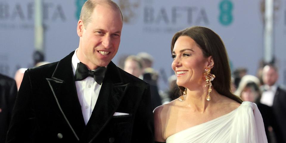 catherine princess of wales and prince william attend the ee bafta film awards together kate is in a white dress with black elbow length gloves and the prince is in a velvet tuxedo