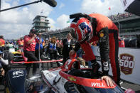 Will Power, of Australia, climbs into his car during qualifications for the Indianapolis 500 auto race at Indianapolis Motor Speedway, Saturday, May 18, 2024, in Indianapolis. (AP Photo/Darron Cummings)