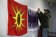 A member of the Tyendinaga Mohawk Territory hangs flags before a news conference