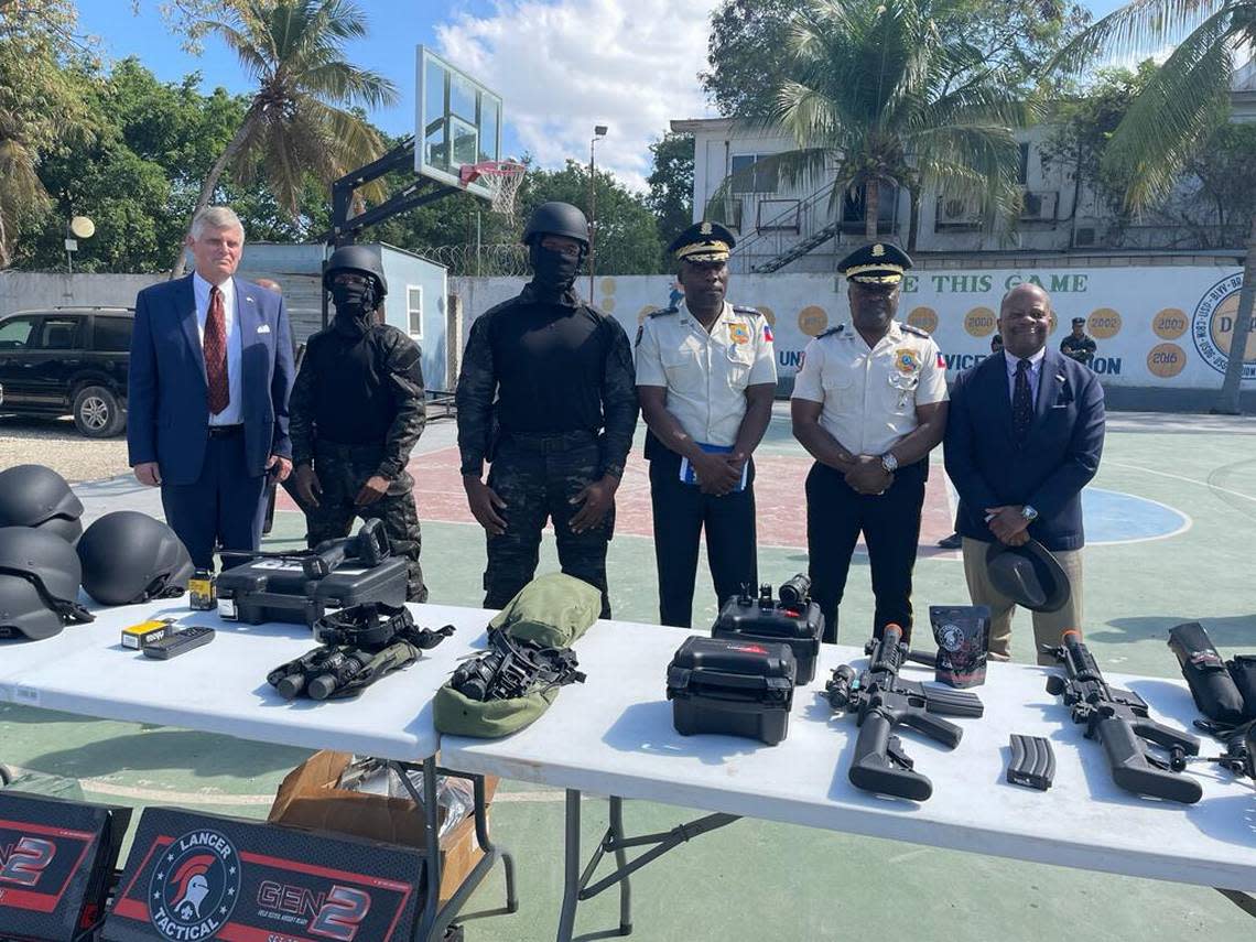 Todd Robinson, assistant secretary for the Bureau of International Narcotics and Law Enforcement, far right, visits the training grounds of Haiti’s new SWAT on Thursday, Jan. 27, 2023. He reviewed some of the police equipment the United States is providing, including new uniforms for the specialized force and night goggles.