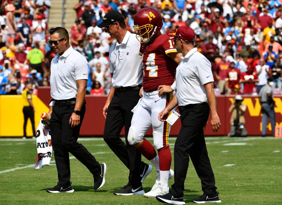 Washington Football Team QB Ryan Fitzpatrick leaves the field after injuring his hip Sunday against the Chargers.