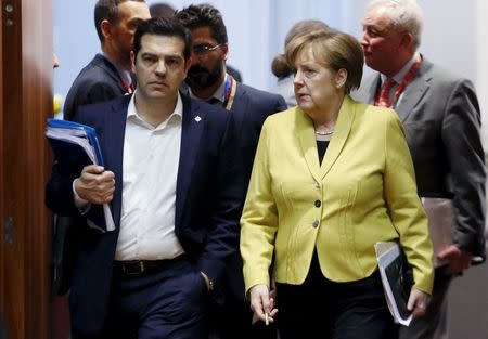 Greece's Prime Minister Alexis Tsipras and Germany's Chancellor Angela Merkel (R) attend a European Union leaders summit on migration in Brussels, Belgium, March 18, 2016. REUTERS/Francois Lenoir
