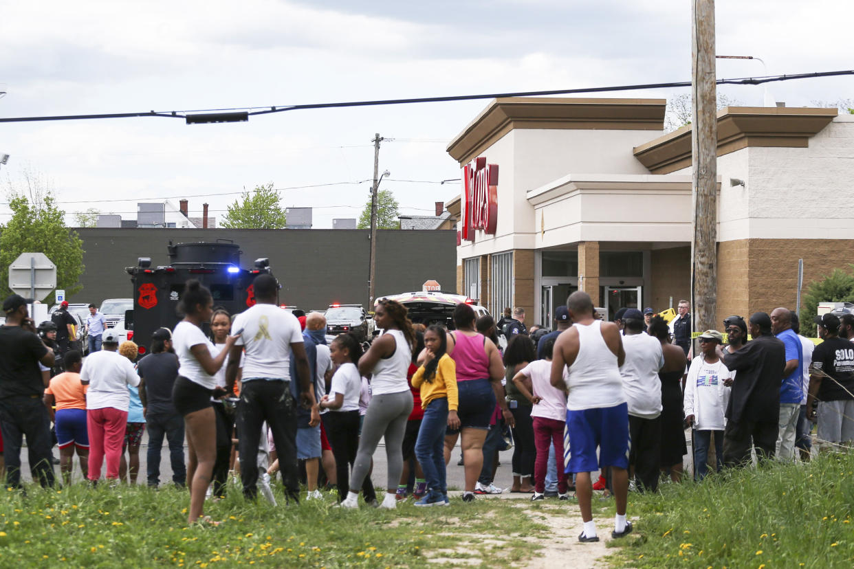 A crowd gathers as police investigate after a shooting at Tops Market (Joshua Bessex / AP)