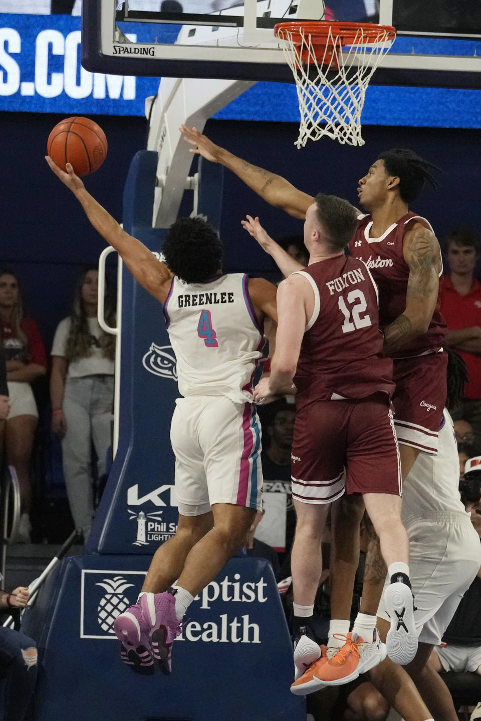 Charleston forward James Scott and guard CJ Fulton (12) defend Florida Atlantic guard Bryan Greenlee (4) during the second half of an NCAA college basketball game, Saturday, Dec. 2, 2023, in Boca Raton, Fla. Florida Atlantic defeated Charleston 90-74. (AP Photo/Marta Lavandier)