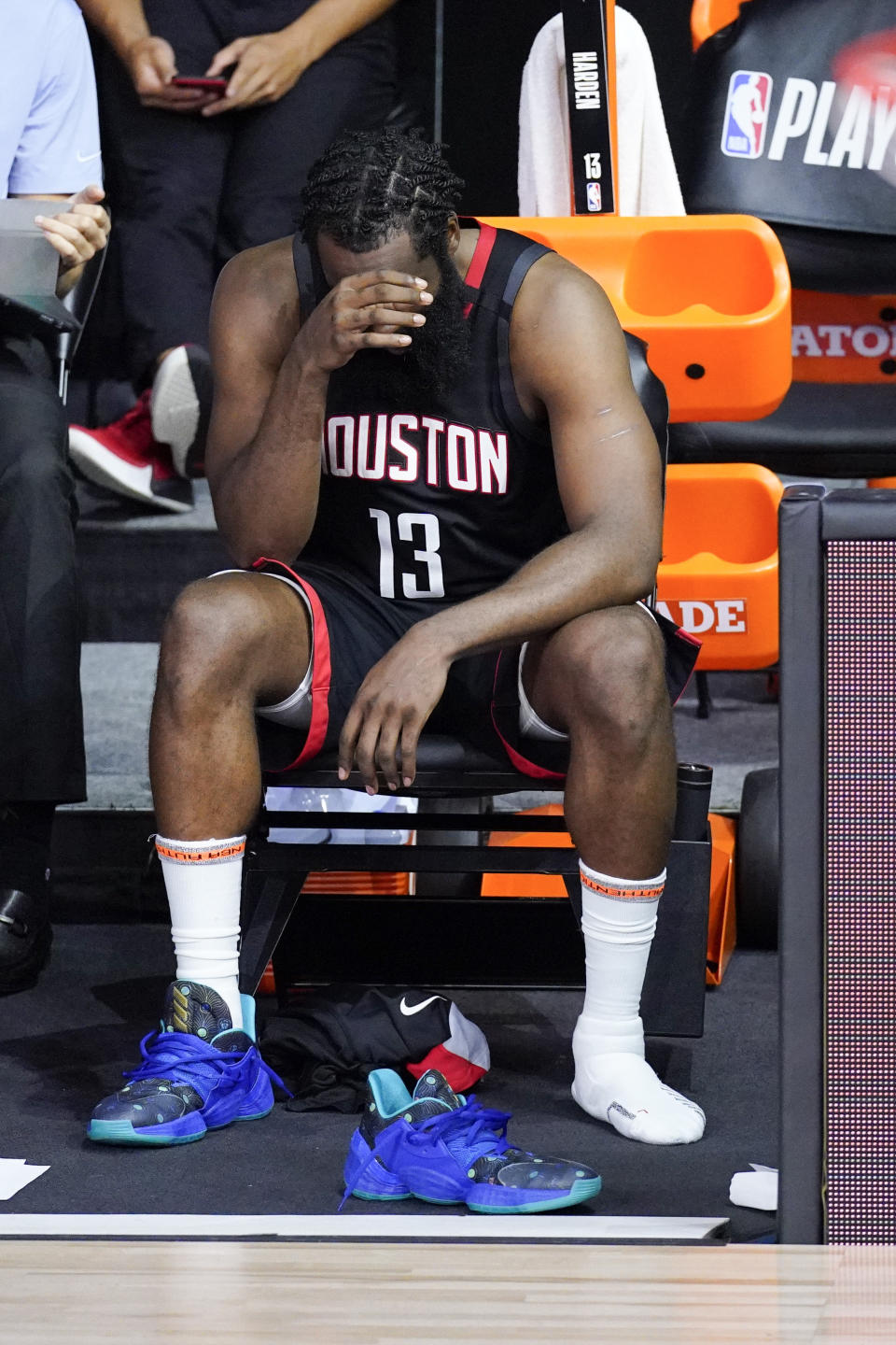 Houston Rockets' James Harden cover his face in the closing minutes of a loss to the Los Angeles Lakers during the second half of an NBA conference semifinal playoff basketball game Saturday, Sept. 12, 2020, in Lake Buena Vista, Fla. (AP Photo/Mark J. Terrill)