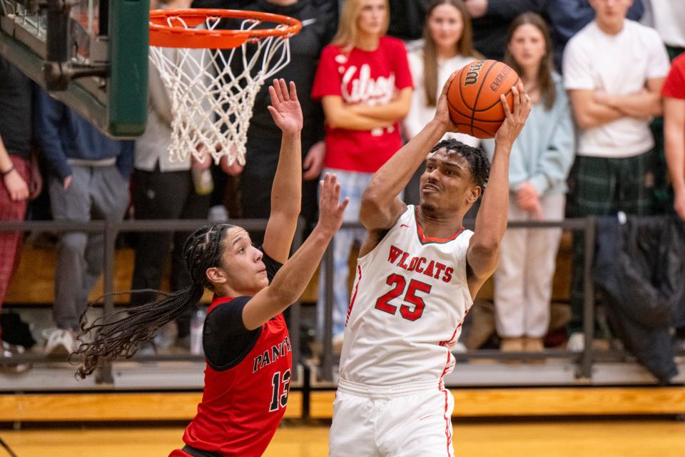 Lawrence North High School sophomore Kai McGrew (25) shoots while being defended by North Central High School junior Papi Rivera (13) during the second half of an IHSAA Class 4A Boys’ Sectional basketball game, Wednesday, Feb. 28, 2024, at Lawrence North High School.