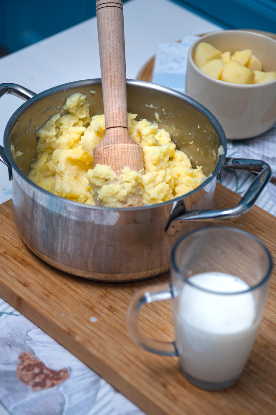 Mashing potatoes in a pot.