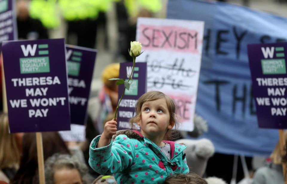 A girl holds a rose as protesters take part in the Women’s March calling for equality, justice and an end to austerity in London, Britain, Jan.19, 2019. (Photo: Simon Dawson/Reuters)