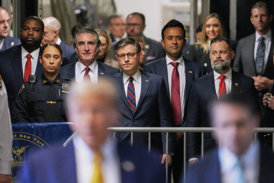 Rep. Byron Donalds, R-Fla., North Dakota Governor Doug Burgum, House Speaker Mike Johnson, former presidential candidate Vivek Ramaswamy and Rep. Cory Mills, R-Fla., listen as former President Donald Trump speaks to reporters (Justin Lane / Pool via AFP - Getty Images)