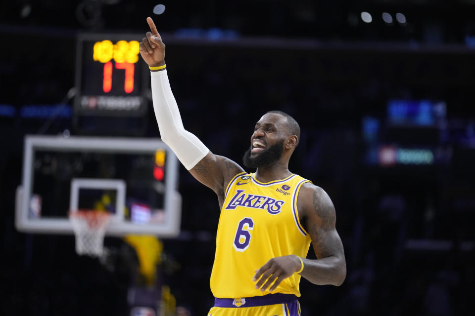 Los Angeles Lakers forward LeBron James signals during the first half of an NBA basketball play-in tournament game against the Minnesota Timberwolves Tuesday, April 11, 2023, in Los Angeles. (AP Photo/Marcio Jose Sanchez)