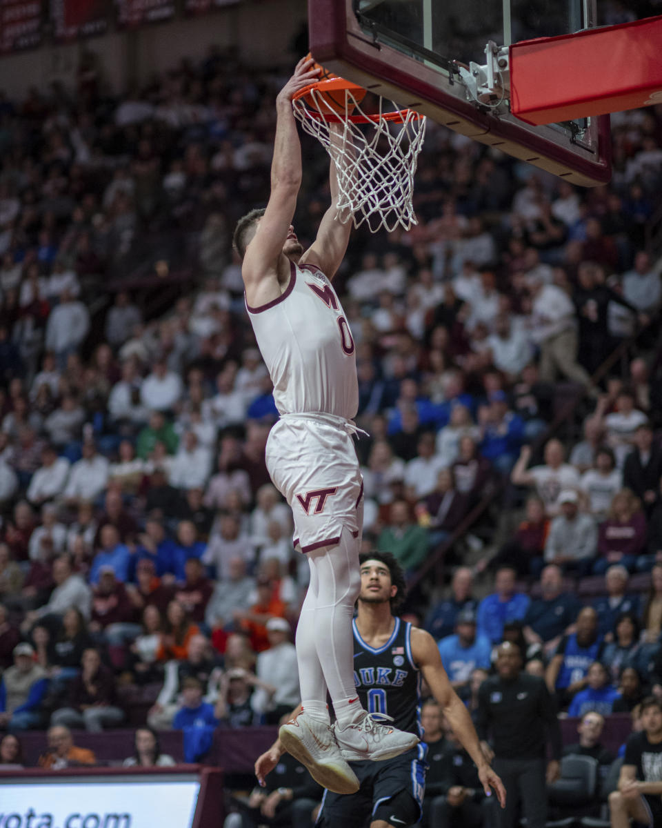 Virginia Tech's Hunter Cattoor, top, dunks against Duke during the first half of an NCAA college basketball game, Monday, Jan. 29, 2024, in Blacksburg, Va. (AP Photo/Robert Simmons)