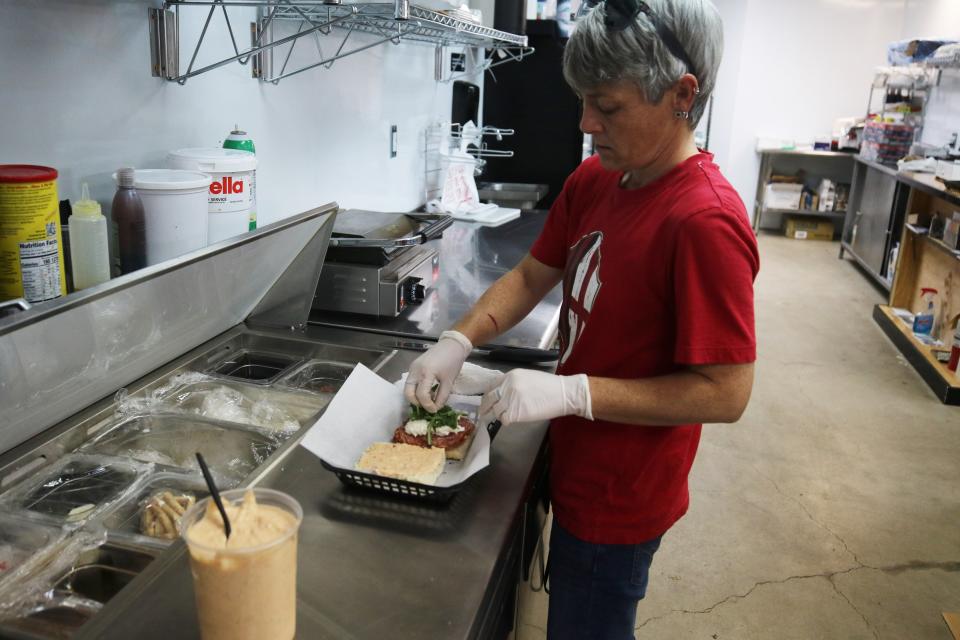 Aimee Aquino prepares Italian-style sandwiches Aug. 7, 2023 at Aquino's Deli in downtown Carlsbad.