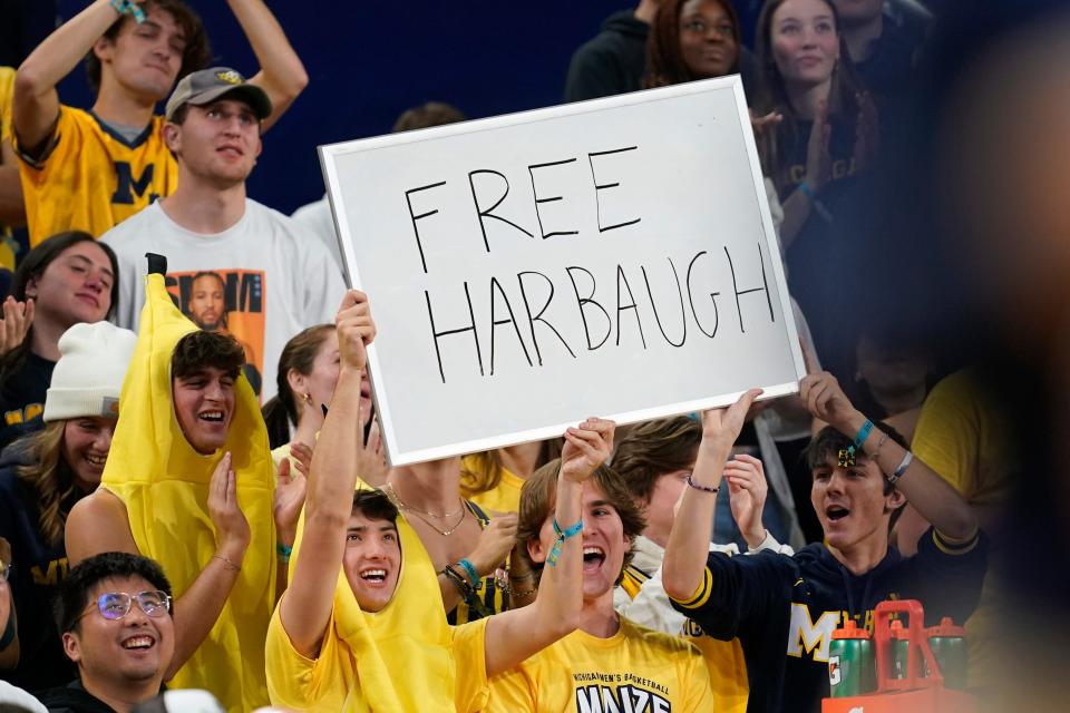 Students hold up a "Free Harbaugh" sign in the first half of an NCAA college basketball game between Michigan and Youngstown State at Crisler Center in Ann Arbor on Friday, Nov. 10, 2023.