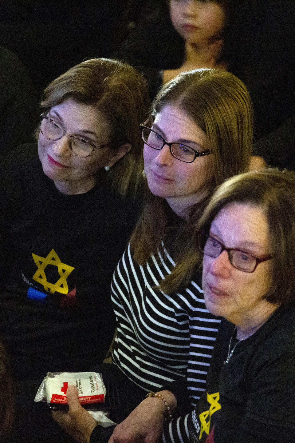 Family members of victim Daniel Stein, including his daughter Leigh Stein, center, and his wife Sharyn Stein, right, embrace during the one-year commemoration of the Tree of Life synagogue attack at Soldiers & Sailors Memorial Hall and Museum, Sunday, Oct. 27, 2019, in Pittsburgh. (AP Photo/Rebecca Droke)