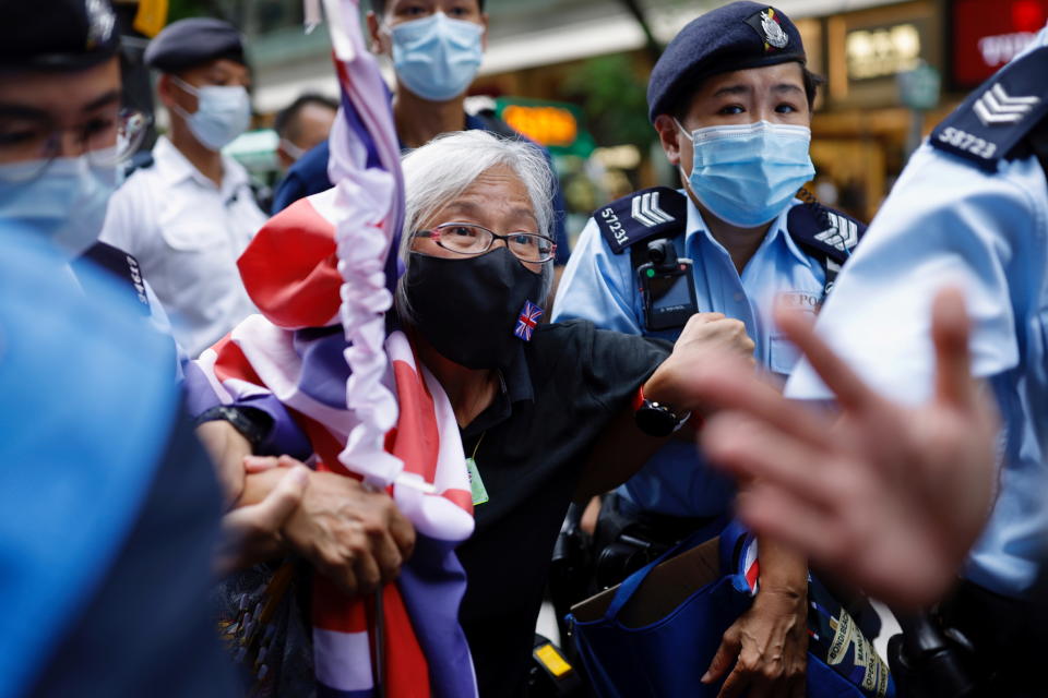 A pro-democracy protester with a Union flag mask is taken by police at Causeway Bay after police denied permission for a protest rally during the 24th anniversary of the former British colony’s return to Chinese rule, on the 100th founding anniversary of the Communist Party of China, in Hong Kong, China July 1, 2021. REUTERS/Tyrone Siu     TPX IMAGES OF THE DAY