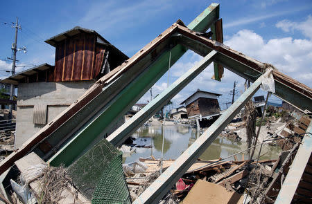 Submerged and destroyed houses are seen in a flooded area in Mabi town in Kurashiki, Okayama Prefecture, Japan, July 10, 2018. REUTERS/Issei Kato