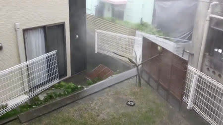 A residential fence breaks open due to heavy rain heavy rain and wind caused by Typhoon Trami in Itoman city, Okinawa prefecture, Japan in this September 29, 2018 photo by @MAXIOKINAWA. Twitter @MAXIOKINAWA/Social Media/via REUTERS